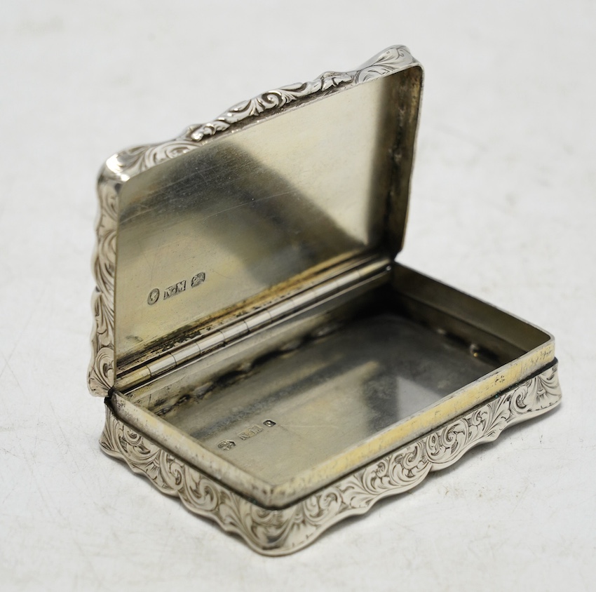 A Victorian engraved silver snuff box, by Nathaniel Mills, Birmingham, 1851, 66mm. Condition - fair